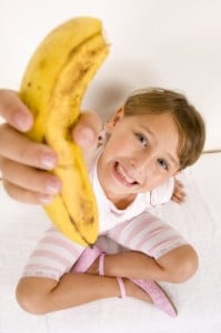 girl holding a banana