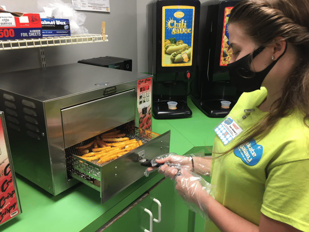 Employee cooking fries with greaseless fryer